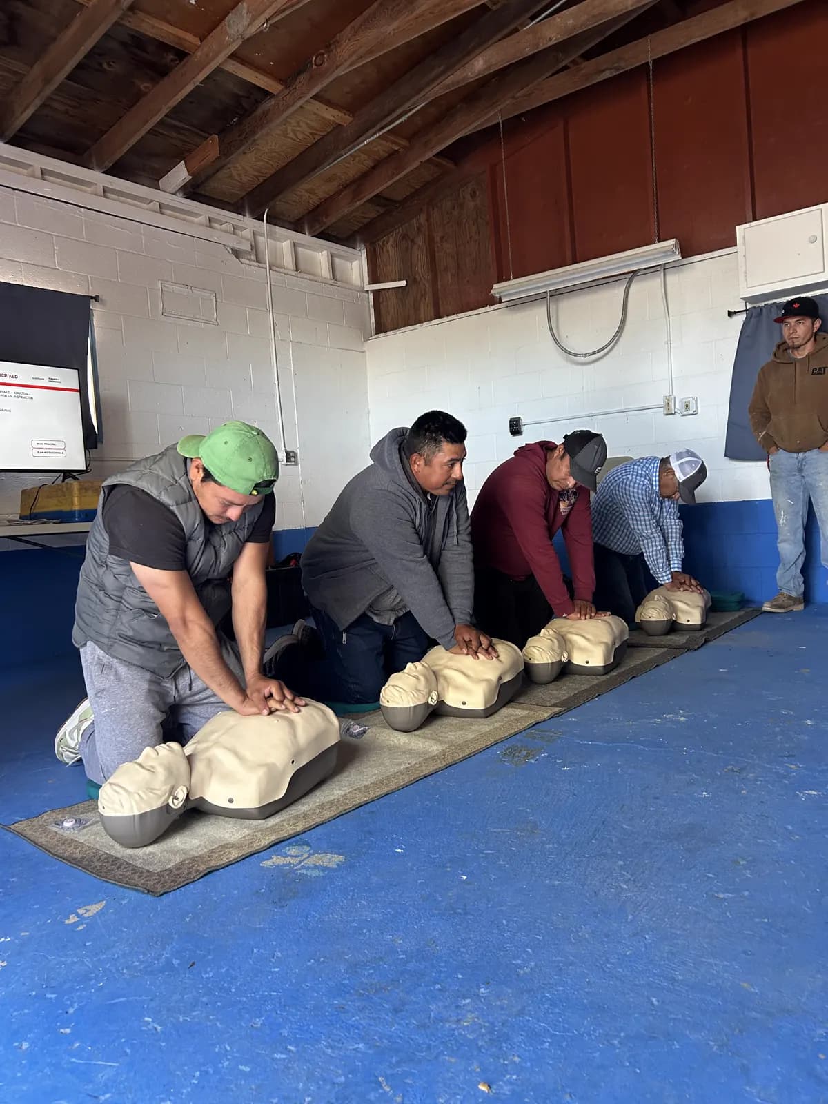 Pearls crew members practicing CPR during first-aid training
