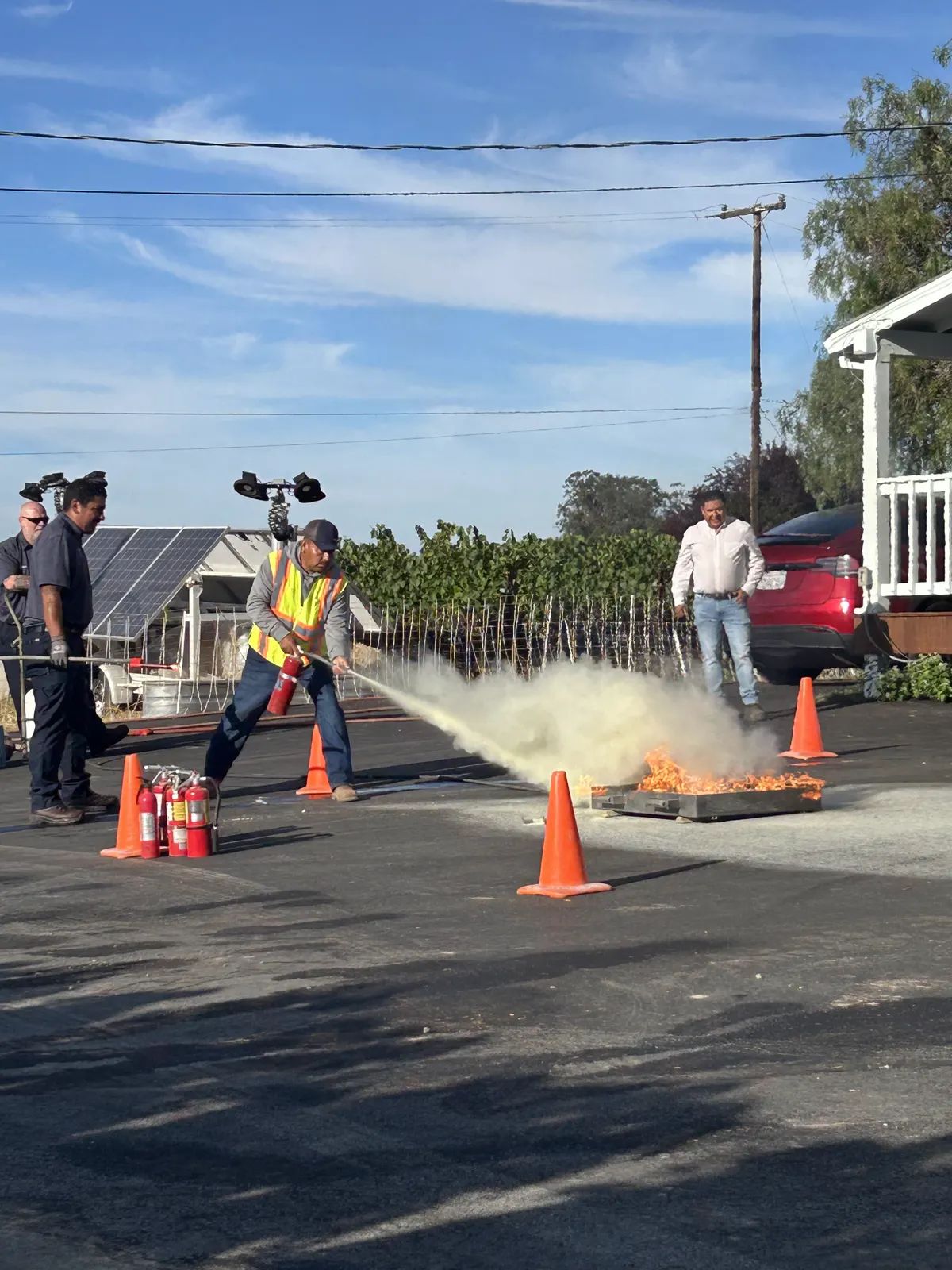 Worker practicing with a fire extinguisher during a safety drill